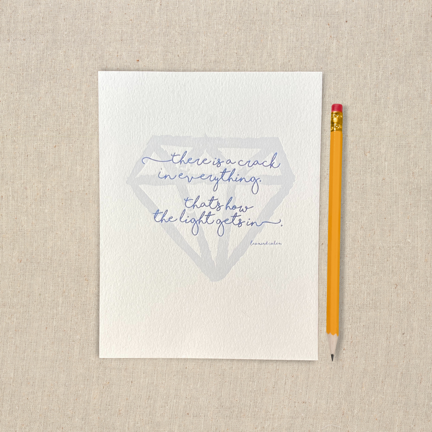 5 x 7 letterpress print with large hand drawn gem shape and hand lettered lyric. There is a crack in everything, that's how the light gets in.