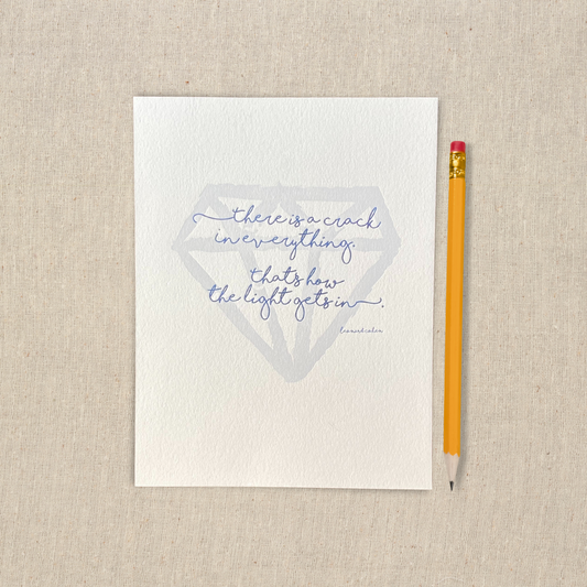 5 x 7 letterpress print with large hand drawn gem shape and hand lettered lyric. There is a crack in everything, that's how the light gets in.
