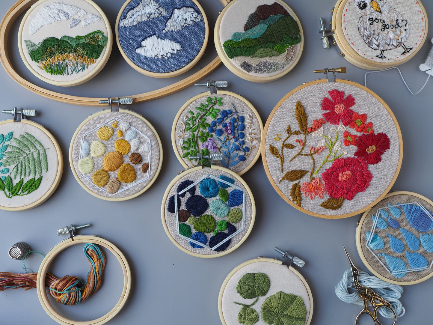 overhead view of 11 stitched embroidery designs