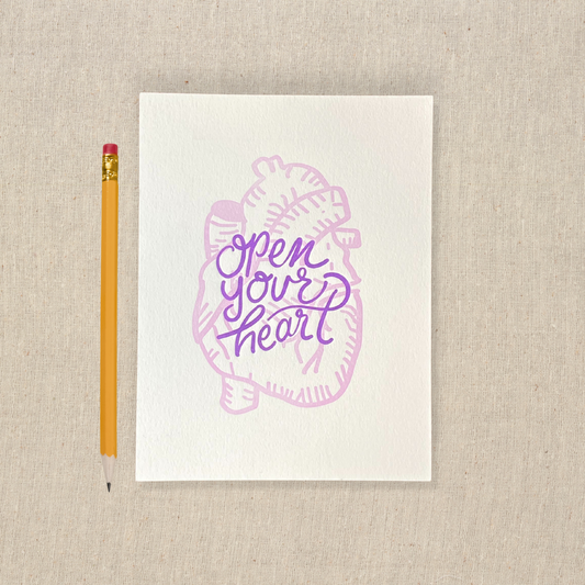5 x 7 letterpress print with lilac anatomical heart drawing and purple lettering that says open your heart