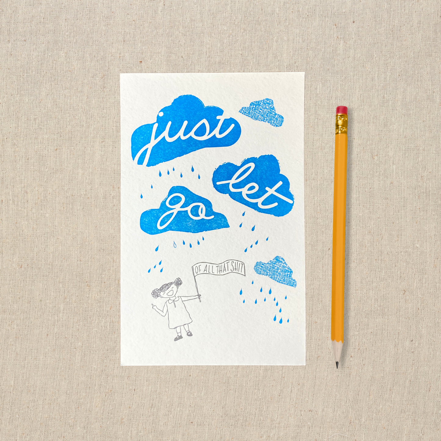 Playful print of small hand drawn figure holding a sign that says of all that shit. Above her are three blue clouds with the words just let go. Letterpress printed. Pencil for scale.